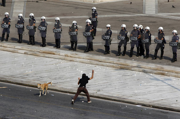 Protester hurls rocks against police during demonstration in Athens